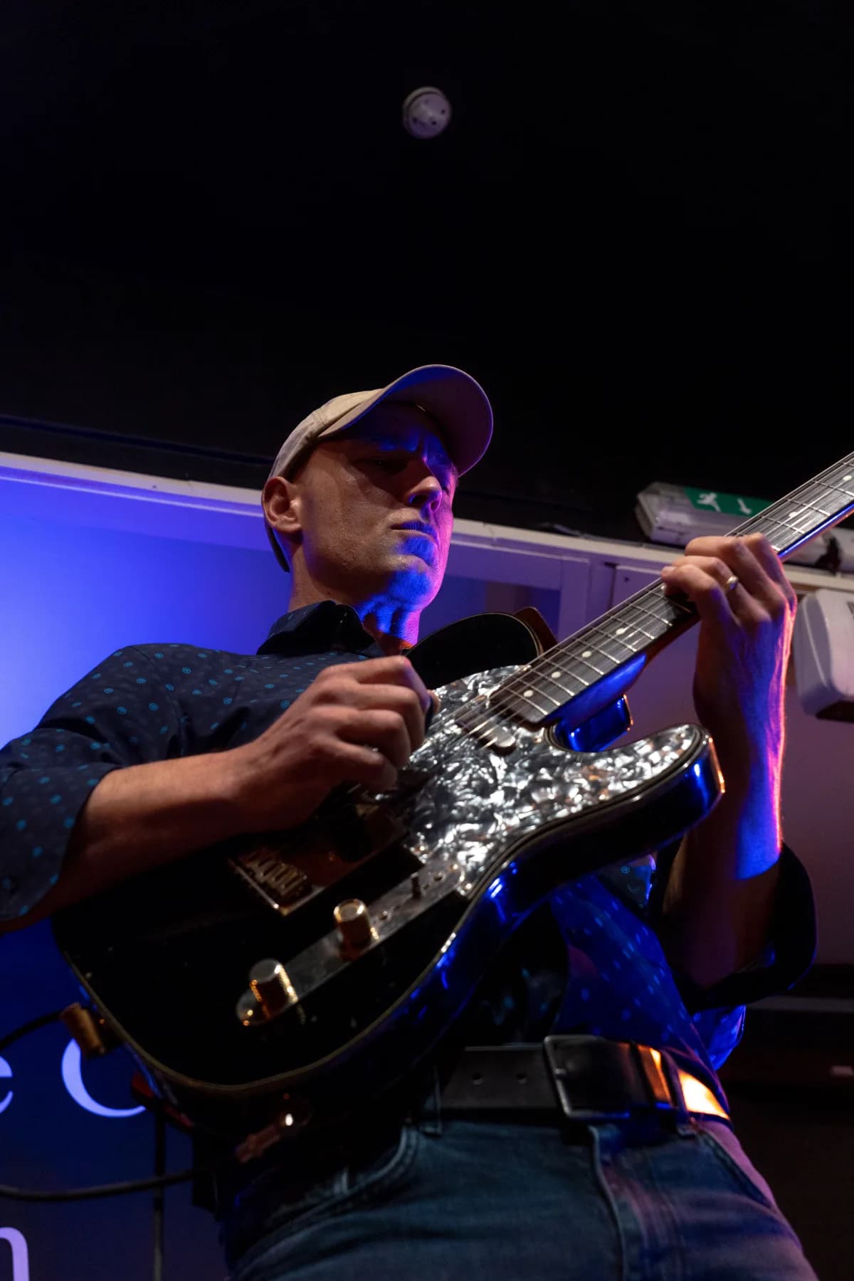 Pete Roth Trio close-up performance image with guitar and drums.