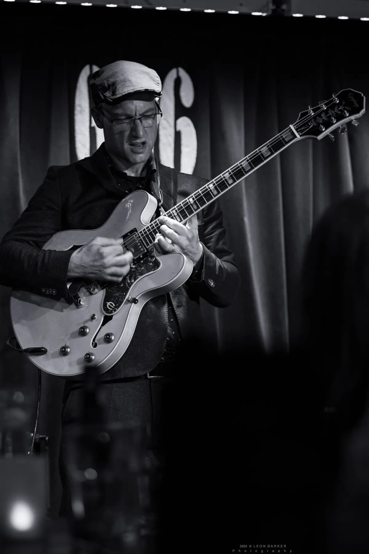 Pete Roth with an electric guitar for Pete Roth Trio.